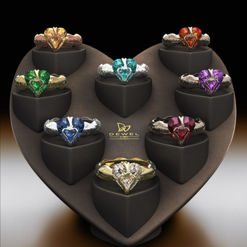 Collection of heart-shaped gemstone rings on a branded display stand.